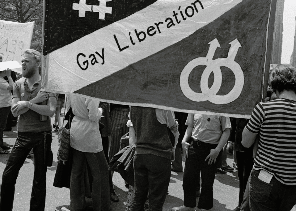 History of LGBTQ+ inclusion in the American workforce image 9 -- activists holding a banner that says Gay Liberation