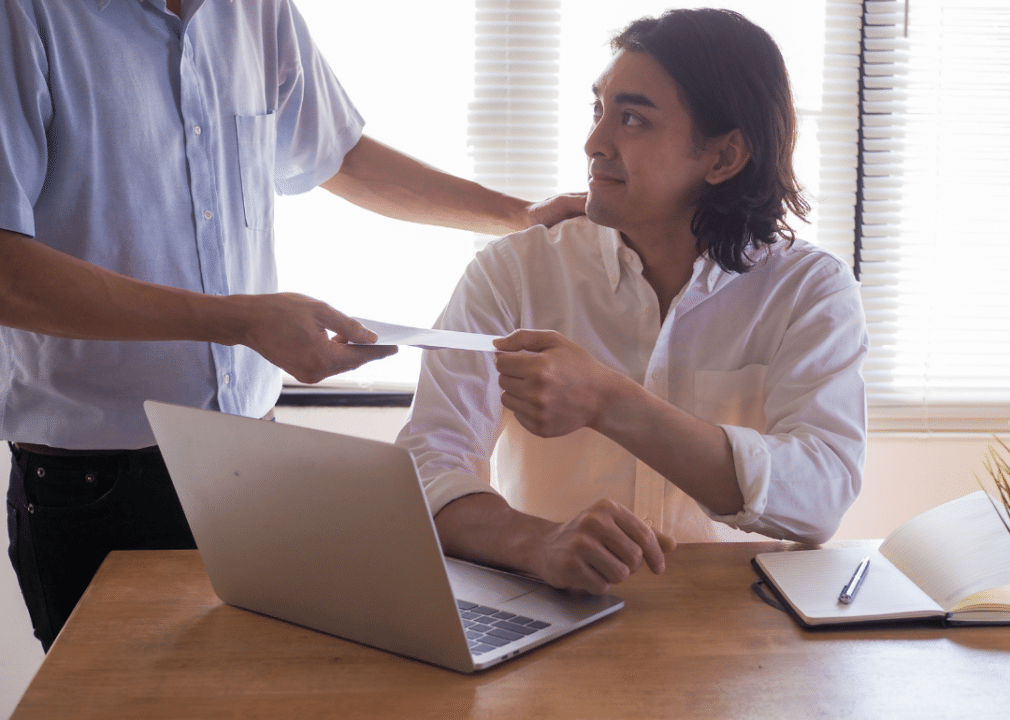 Man giving cheque to someone - wave of salary increase